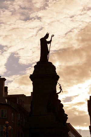 Sunset silhouette of the 1908 monument statue of Bishop Francois de Laval in Old Quebec city, Canada. He was the first Roman Catholic bishop of Quebec.の写真素材