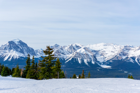 Snow-capped mountain landscape showing Mount Victoria glacier of the Canadian Rockies at Lake Louise near Banff National Park in Alberta, Canada.の写真素材