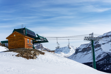Final stop of a ski lift in the Canadian Rockies of Lake Louise with empty lift chairs.の写真素材