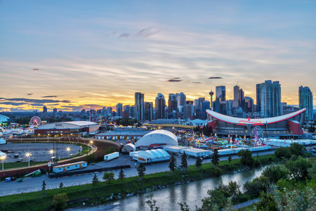 CALGARY, CANADA - JULY 14, 2019: Sunset over Calgary skyline with the annual Stampede event at the Saddledome grounds. The Calgary Stampede is renowned as the greatest outdoor show on Earth.のeditorial素材