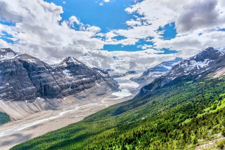 Sweeping vista of Saskatchewan Glacier flowing from the Columbia Icefields as seen from the crest of Parker Ridge on the Icefields Parkway in Jasper National Park in the Canadian Rockies. Mount Athabasca can be seen in the background.の写真素材