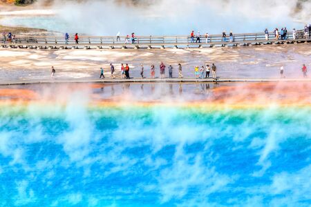 YELLOWSTONE, USA - AUG 24, 2019: Tourists on the boardwalk at Grand Prismatic Spring, the largest hot spring at Yellowstone National Park.のeditorial素材