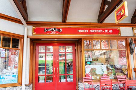 BANFF, CANADA - FEB 15, 2020 : Famous Canadian-based BeaverTails restaurant with its sign on busy Banff Avenue in Alberta, Canada.のeditorial素材