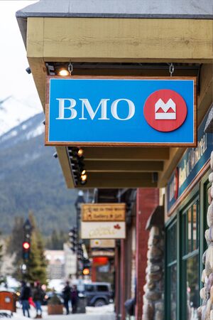 BANFF, CANADA - FEB 15, 2020 : BMO Bank of Montreal Branch with its sign on busy Banff Avenue in Alberta, Canada.  BMO is a Canadian multinational investment bank and financial services company founded in Montreal.のeditorial素材