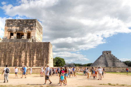Chichen Itza, Mexico - Dec. 23, 2019: Tourists visit the famous Kukulcan pyramid at Chichen Itza in ...
