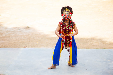 Bintan Island, Indonesia - July 23, 2017: Native Indonesian dancer wears a Topeng mask and ornate...