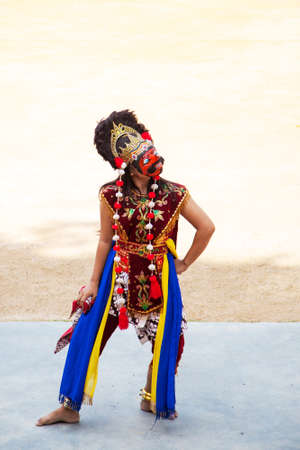 Bintan Island, Indonesia - July 23, 2017: Native Indonesian dancer wears a Topeng mask and ornate costume while performing traditional narratives of fabled kings, heroes and myths, accompanied by gamelan music.のeditorial素材