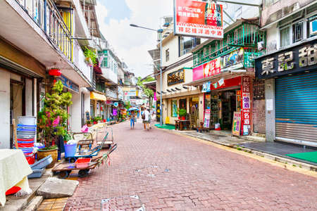 Hong Kong, Hong Kong SAR - July 14, 2017: Residents and visitors stroll along the main street in old town Sai Kung village. The laidback seaside town is famous for its seafood restaurants and floating seafood market.のeditorial素材