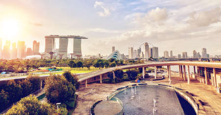 Sunset panorama of Singapore skyline from the Marina Barrage. The Barrage is a reservoir dam in the Marina channel waterway of southern Singapore and serves as a public park popular with local residents.のeditorial素材