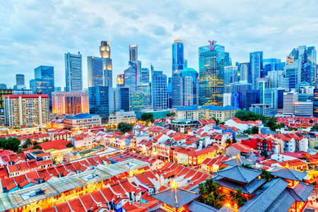 Aerial view of the evening cityscape of Singapore Chinatown with downtown skyscrapers of the business financial district in the background.のeditorial素材