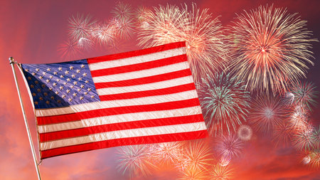 Flag of the United States of America flying high in the sunset sky with fireworks. Concept of July 4 Independence Day, Memorial Day or other US celebrations.の写真素材