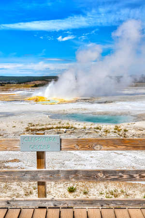 Clepsydra Geyser erupts at Fountain Paint Pot trail in the Lower Geyser Basin of Yellowstone National Park in Wyoming, USA. The geyser constantly splashes from several vents and its steam can be seen widely.の写真素材