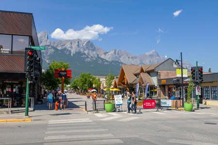 CANMORE, CANADA - JULY 30, 2020: Tourists walk along popular downtown Canmore in the Canadian Rockies. The road was closed to traffic due to COVID-19 to allow for more social distancing among visitors.のeditorial素材