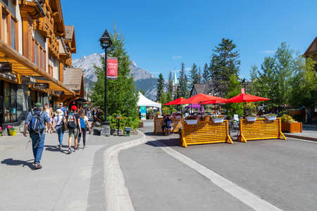 BANFF, CANADA - JULY 29, 2020: Tourists walk and dine along Banff Avenue in Banff National Park. The street was closed due to COVID-19 to allow for more social distancing among visitors.のeditorial素材