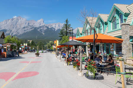CANMORE, CANADA - JULY 30, 2020: Tourists dining along popular downtown Canmore in the Canadian Rockies. The road was closed to traffic due to COVID-19 to allow for more social distancing among visitors.のeditorial素材