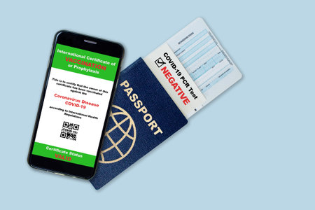 Smartphone on travel passport, boarding pass with digital certificate of COVID-19 vaccination and proof of negative COVID test result. Concept of new normal future air or land border travel restrictions and requirements. Fake QR code.の写真素材