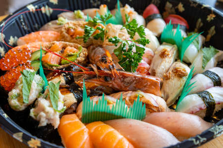 Variety of Japanese sushi food with tuna, salmon, shrimp, scallop, calamari, fish roe.の写真素材
