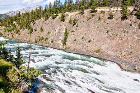 Roaring rapids along Bow Falls trail flowing toward Bow Falls, a major waterfall on the Bow River in the Canadian Rockies of Banff National Park, Alberta, Canada.の写真素材