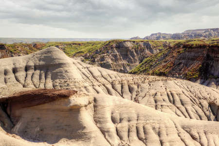 Dinosaur Provincial Park in Alberta, Canada, a  noted for its striking badland topography and abundance of dinosaur fossils, one of the richest fossil locales in the world.の写真素材