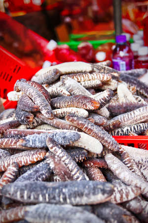Dried sea cucumber for sale in a Chinese market in Tai O, Lantau Island, Hong Kong. They are popular seafood delicacies for use as ingredients in Chinese cooking cuisines.の写真素材