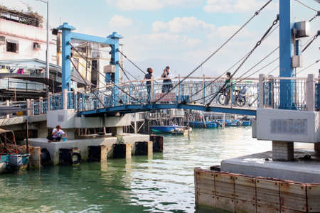 HONG KONG-APR. 11, 2011: Tai Chung Bridge marks the entrance to Tai O, a fishing town on Lantau Island in Hong Kong. Here, houses on stilts above the tidal flats are home to the Tanka people who form a tightly knit fishing community that literally lives oのeditorial素材