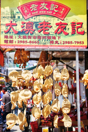 HONG KONG-APR. 10, 2011: Dried fish maws hang onto a street market sign in Tai O, Lantau Island. They are popular seafood delicacies for use as ingredients in Chinese cooking cuisines.のeditorial素材