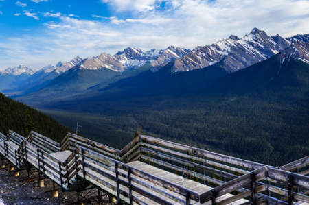 A wooden walkway on top of Sulphur Mountain with panoramic view of the Canadian Rockies in Banff National Park, Alberta, Canada.の写真素材