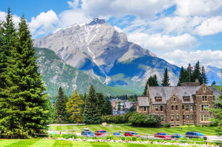 Cascade Mountain as seen from Cascades of Time Gardens at Banff National Park with the historic Parks Canada admin building in the foreground.の写真素材