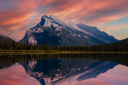 Beautiful golden sunset on Vermillion Lakes in the Canadian Rockies of Banff National Park, Alberta, Canada, with Mount Rundle reflecting on the calm waters.の写真素材