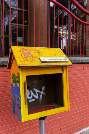Calgary, Canada - November 13, 2021: Neglected roadside Little Free Library box in downtown Calgary Chinatown. A Little Free Library is a free book-sharing box where anyone may take a book or share a book. They function on the honor system.のeditorial素材