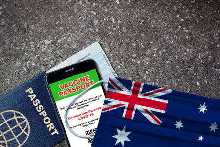 Australia new normal travel with passport, digital vaccine on smartphone, boarding pass and face mask with Australian flag. Vaccine passport concept with copy space.の写真素材