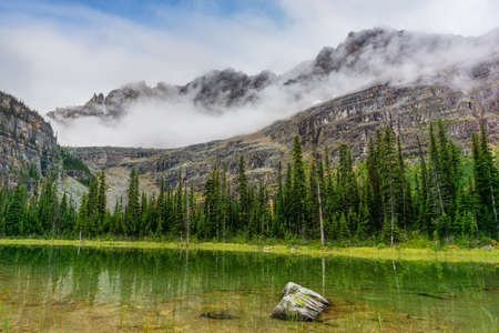 Heavy clouds cover the mountains of Lake O'Hara in the Canadian Rockies of Yoho National Park, British Columbia, Canada.の写真素材
