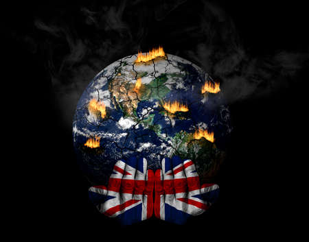 Hands painted with British flag holding stressed planet in crisis. Concept of the role of UK in climate crisis; natural disasters, global warming, apocalypse, war, judgment day.の写真素材