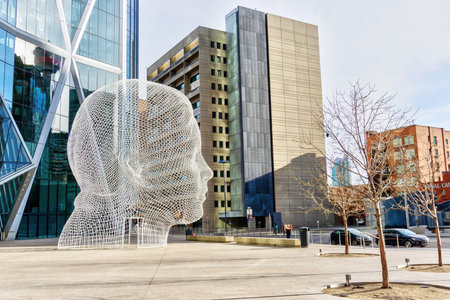 CALGARY, CANADA - NOV. 13. 2021: Wonderland sculpture by Jaume Plensa in front of the Bow Tower in downtown Calgary, Alberta, Canada.のeditorial素材