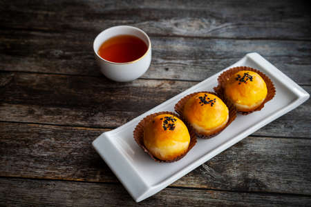 Favorite traditional Chinese pastries baked with fluffy dough and filled with salted egg yolk and sweet paste. The popular cookie is a favorite snack during Chinese New Year and Mooncake festival.の写真素材