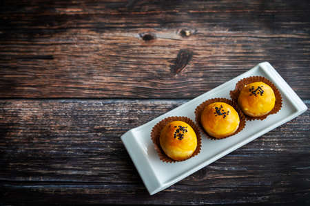 Favorite traditional Chinese pastries baked with fluffy dough and filled with salted egg yolk and sweet paste. The popular cookie is a favorite snack during Chinese New Year and Mooncake festival.の写真素材