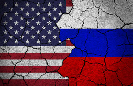 Flags of US and Russia painted on a concrete wall. Concept of crisis, broken relationship, diplomacy.の写真素材