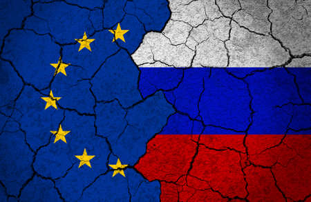 Flags of EU and Russia painted on a concrete wall. Concept of crisis, broken relationship, diplomacy between European Union and Russia.の写真素材
