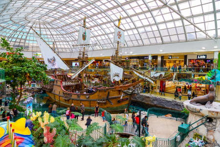 EDMONTON, CANADA - APRIL 16, 2022: Shoppers visit the West Edmonton Mall in Alberta, Canada. At 5.3 million sq ft, it is the second largest shopping mall in North America.のeditorial素材