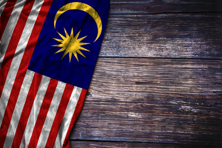 Malaysian flag on rustic wooden background for Malaysia National Day, Remembrance Day or Labor Day concept.の写真素材