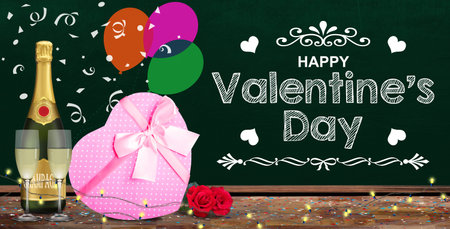 Happy Valentine's Day banner with chalkboard message surrounded by pink gift box, champagne, confetti and string lights.の写真素材