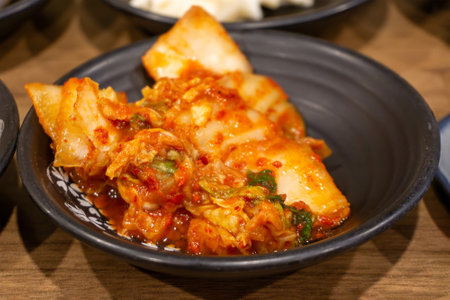 Spicy Korean fermented or aged cabbage known as Kimchi which is a traditional mainstay in Korean cuisine.の写真素材