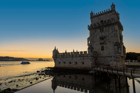 Historic Belem Tower or Torre de Belem on the bank of the Tagus River at sunset in Lisbon, Portugal. Built in 1514 to defend Lisbon from enemy ships, it is a UNESCO World Heritage Site.の写真素材