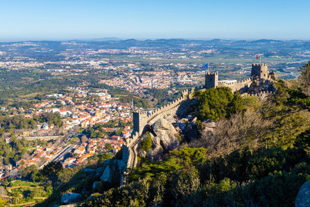 Unrecognizable visitors walking along the Castle of the Moors, or Moorish Castle, a historic 8th century hilltop medieval castle overlooking the town of Sintra, Portugal. UNESCO World Heritage Site.の写真素材
