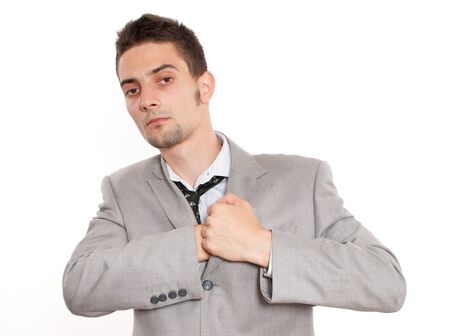 Handsome young caucasian businessman reaching into his pocketの写真素材