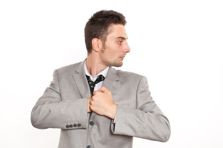 Handsome young caucasian businessman reaching into his pocketの写真素材