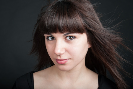 Portrait of lovely teenage girl on a dark backgroundの写真素材