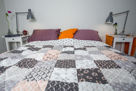 Modern bedroom detail interior design with two lamps and bed