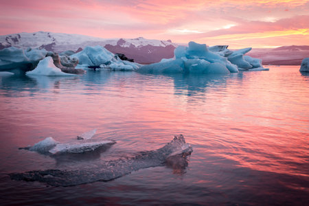 Iceland, Jokulsarlon Glacier Lagoon, icebergs and ice chunk at sunset