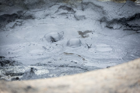 Hverir, geothermal area in Northern Iceland, with steam and mud pools. tourists enjoying the view